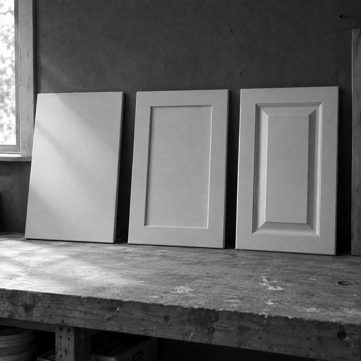 Render of three kitchen cabinet door styles side by side: slab, shaker and raised panel.